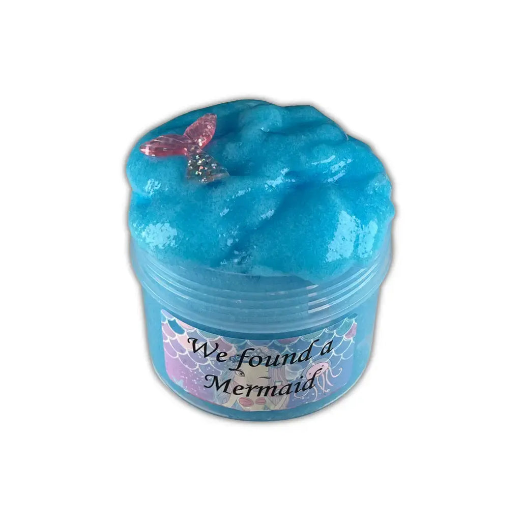 Thick & playful DIY blue color slime in a container and a mermaid toy in slime