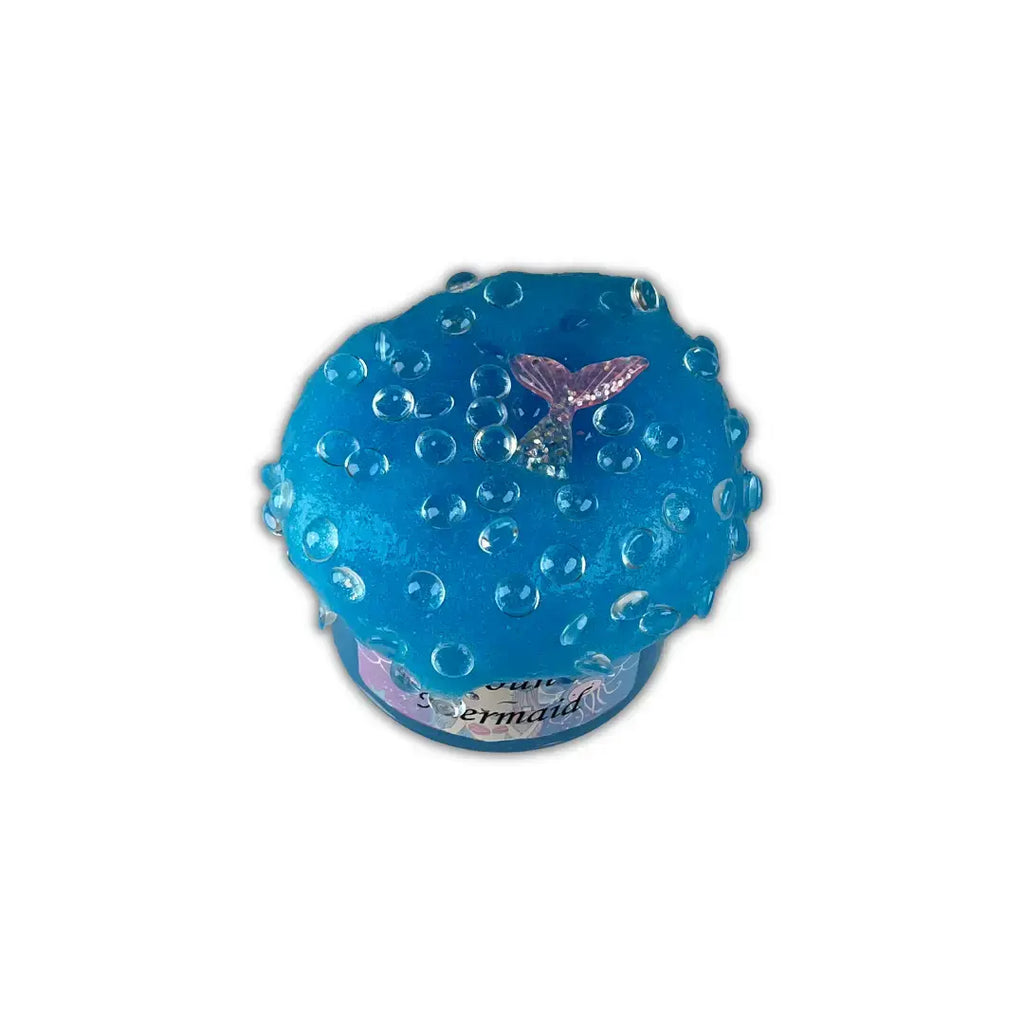 Top view of Handmade clear glue blue color jelly slime in a container topped with fish bowl beads